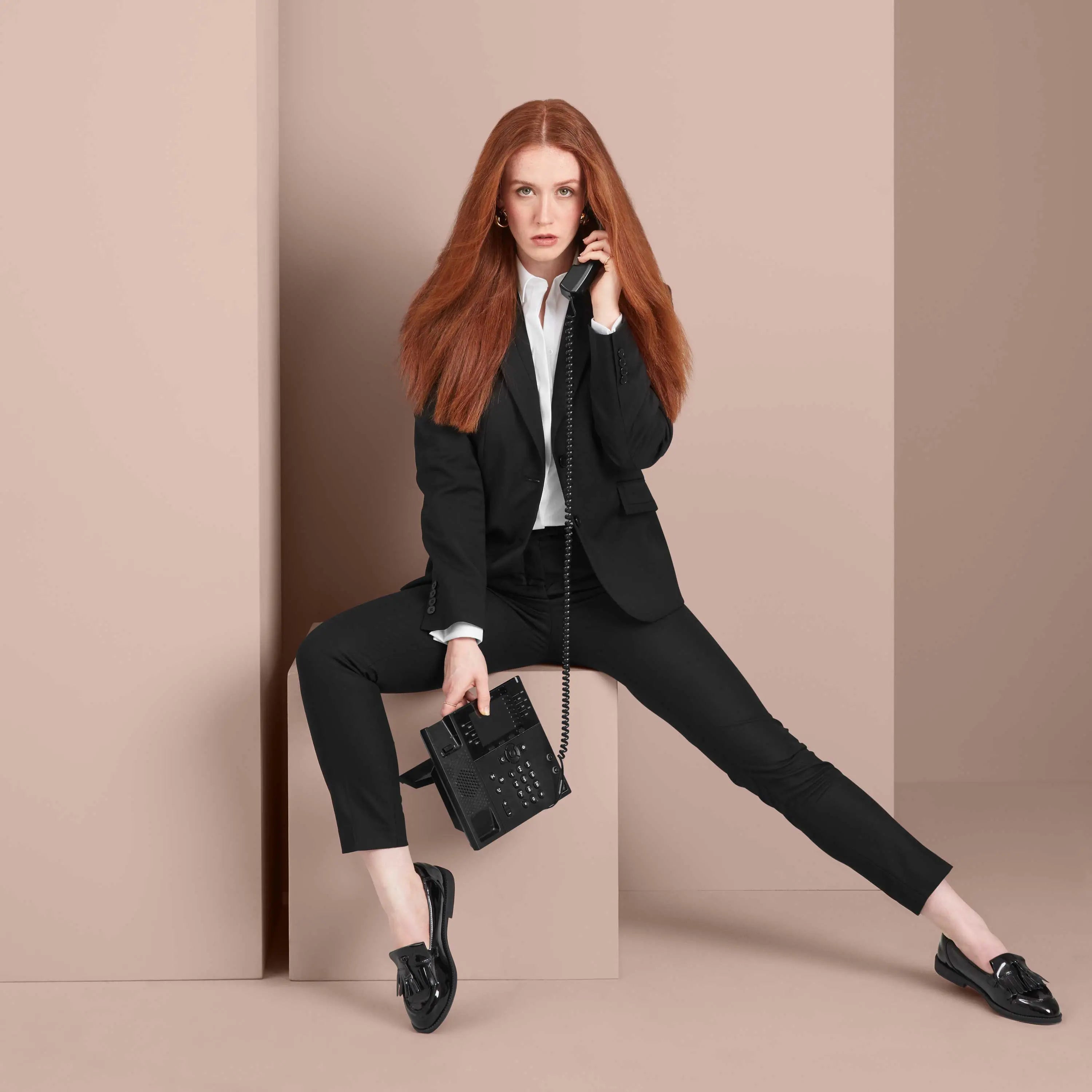 A female model wearing a black suit
