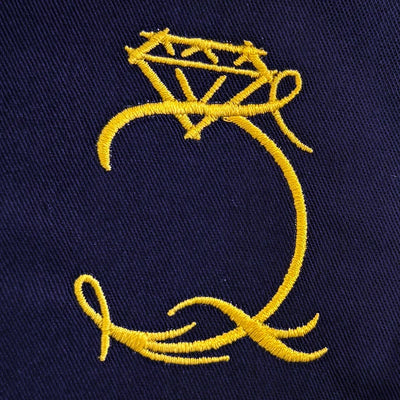 Navy blue fabric with a yellow embroidered ring design