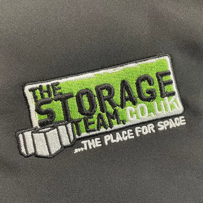 Embroidered patch on a dark background with 'The Storage Team Co. UK' text.