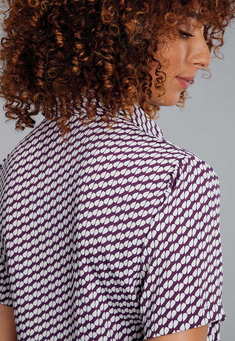 Back View of Model Wearing Disley Ava Patterned Blouse in Aubergine Petals