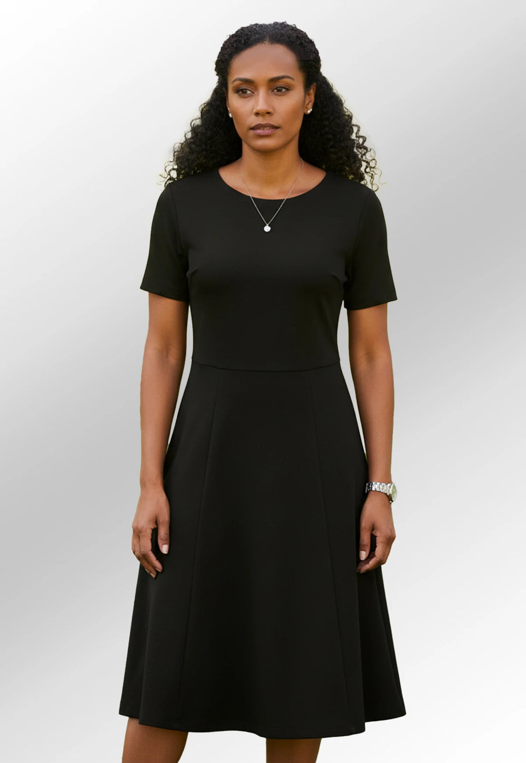Woman wearing the Black Jersey Stretch Skater Funeral Dress from Brook Taverner