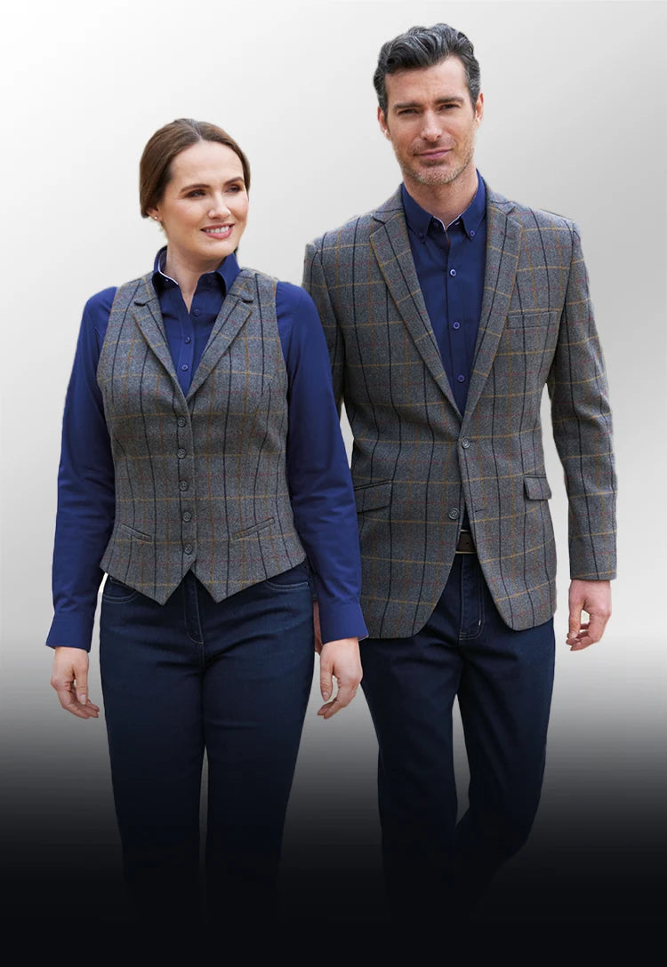 Man and woman wearing matching gray checkered waistcoat/jacket and blue shirts from the Brook Taverner Casuals and Separates Colelction
