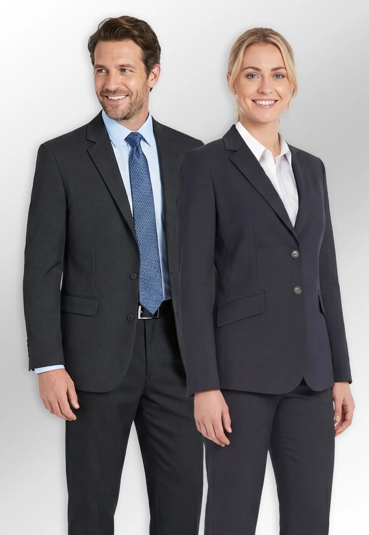 Man and woman in formal business attire from the Brook Taverner Concept Collection, standing side by side.