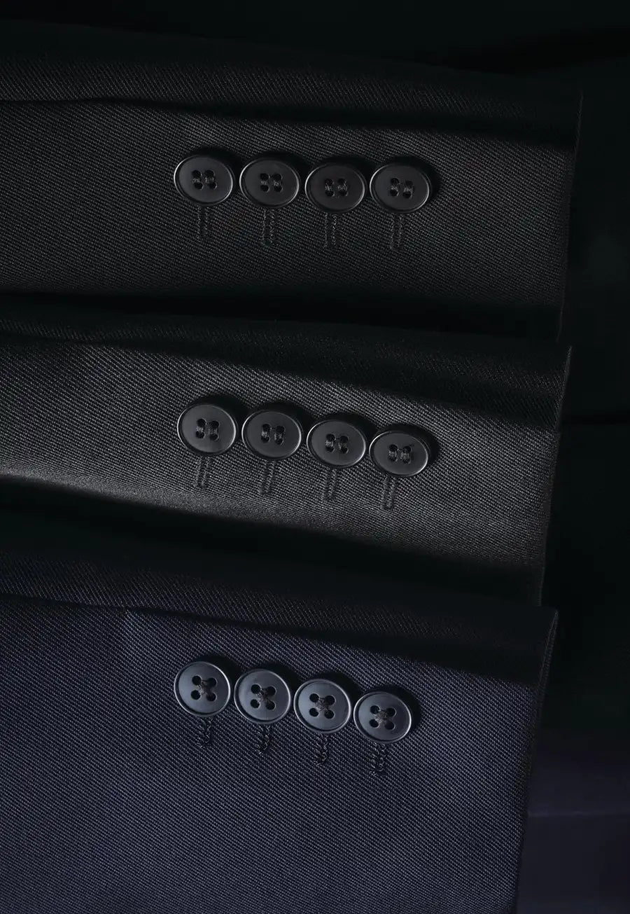 Close-up detail of Concept Collection suit jacket sleeves, showing the fabric texture and four matching buttons on the cuff.