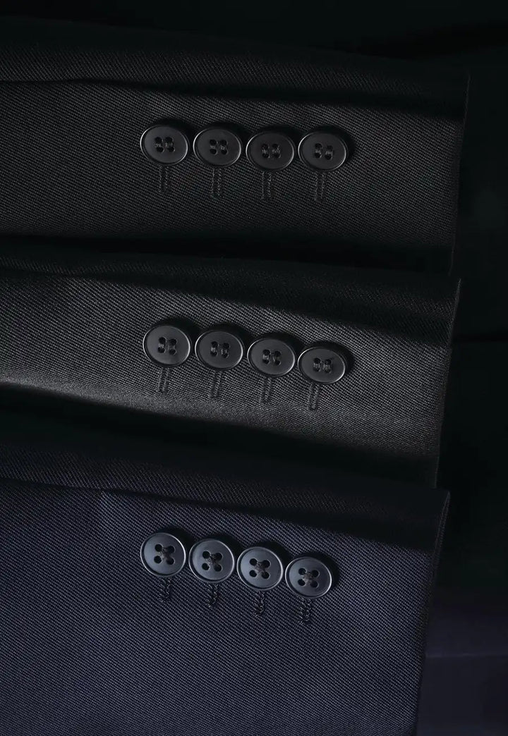 Close-up detail of Concept Collection suit jacket sleeves, showing the fabric texture and four matching buttons on the cuff.