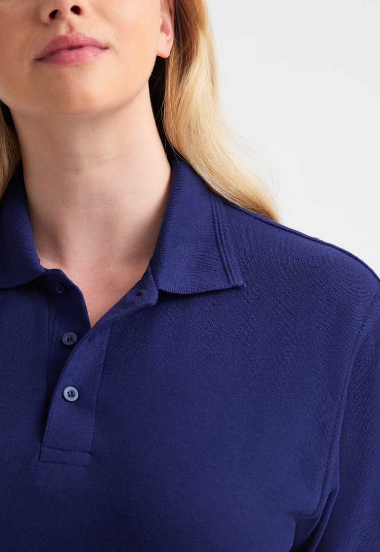 close up of model wearing Deluxe Polo Shirt in navy