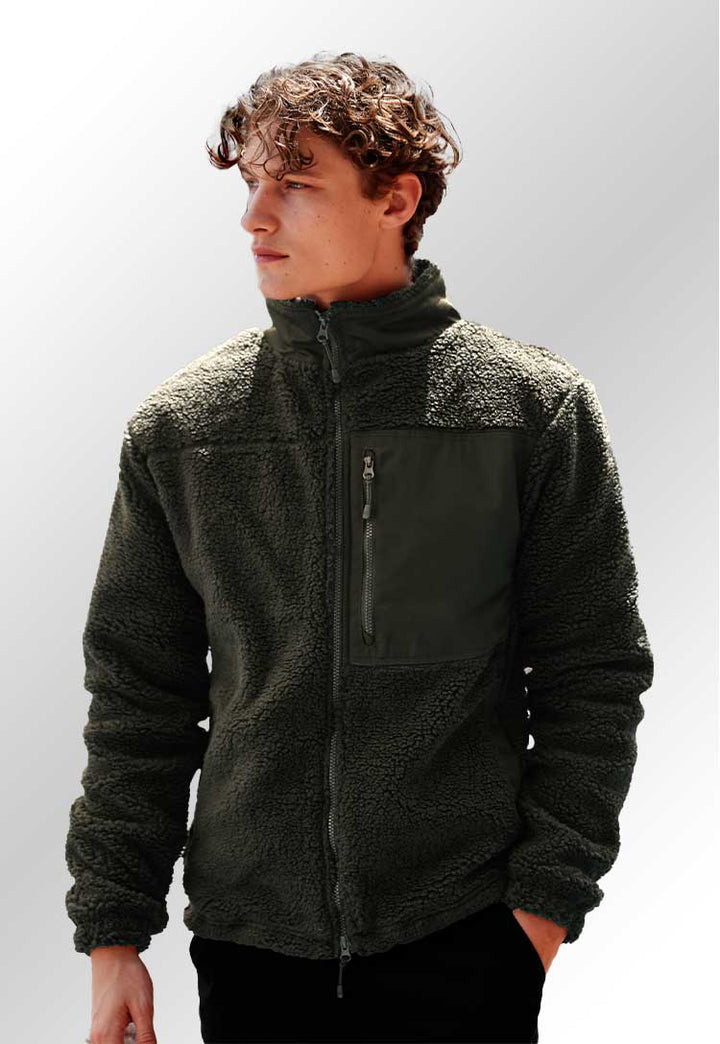 A model wearing an FR854 Recycled sherpa fleece in Dark Olive