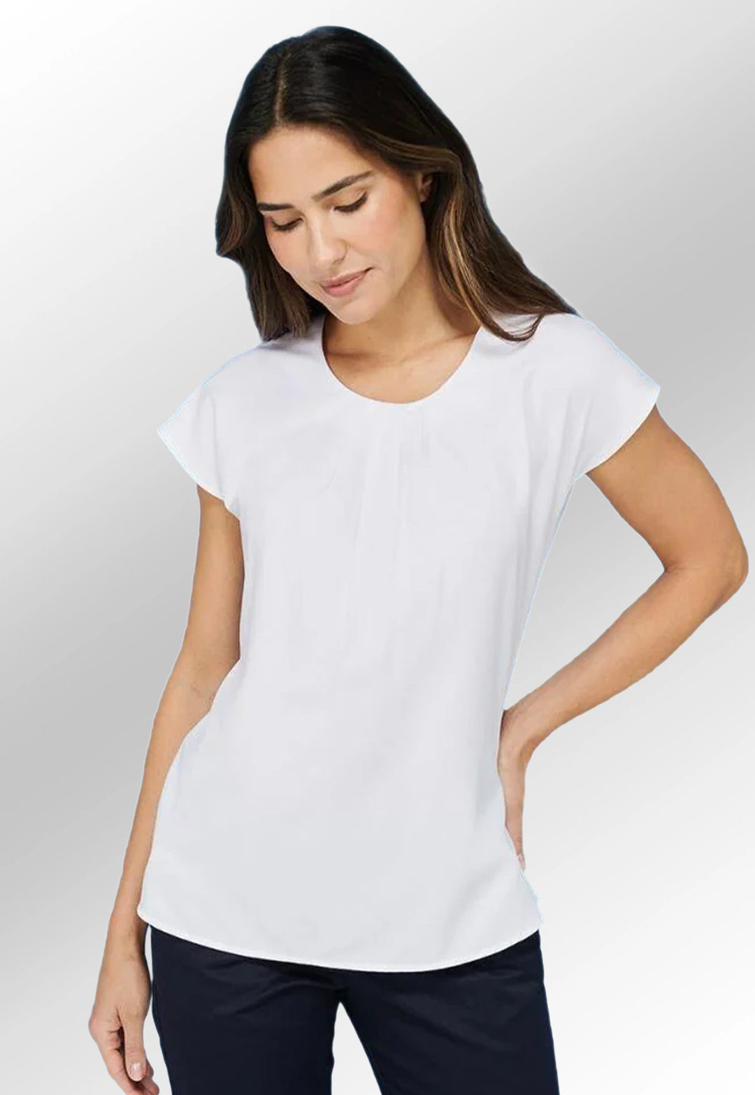 Model wearing the Henbury Women's Pleat Front Short Sleeve Blouse HB597 in White.