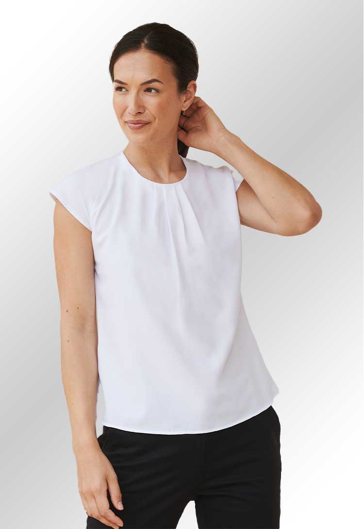 Model wearing a HB597 Women's pleat front short sleeve blouse in White