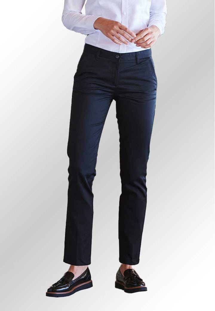 Model's legs wearing HB641 Women's 65/35 flat fronted chino trousers in Navy