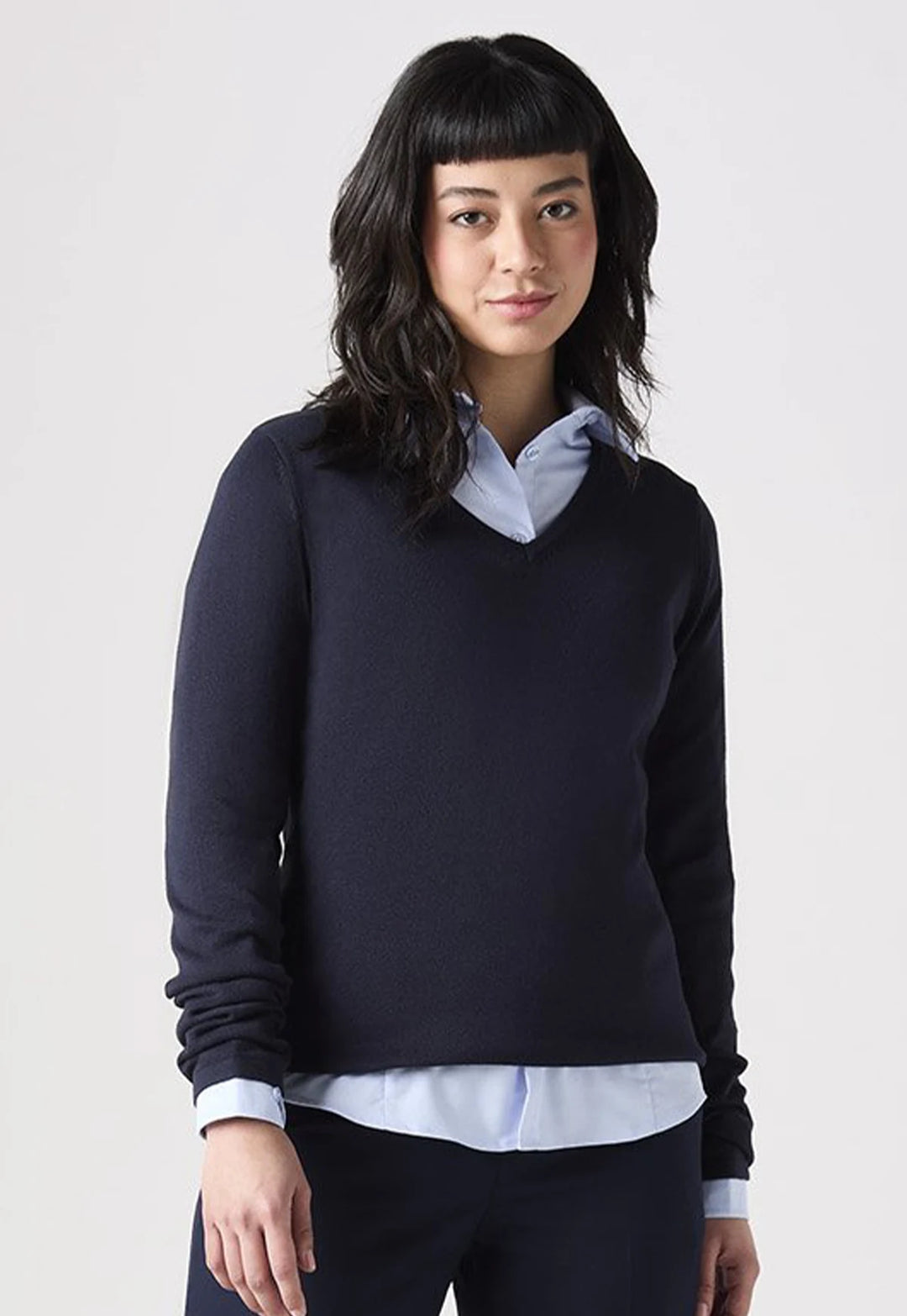 Model wearing the Henbury Women's 12 Gauge V Neck Jumper in Navy paired with a collared shirt.