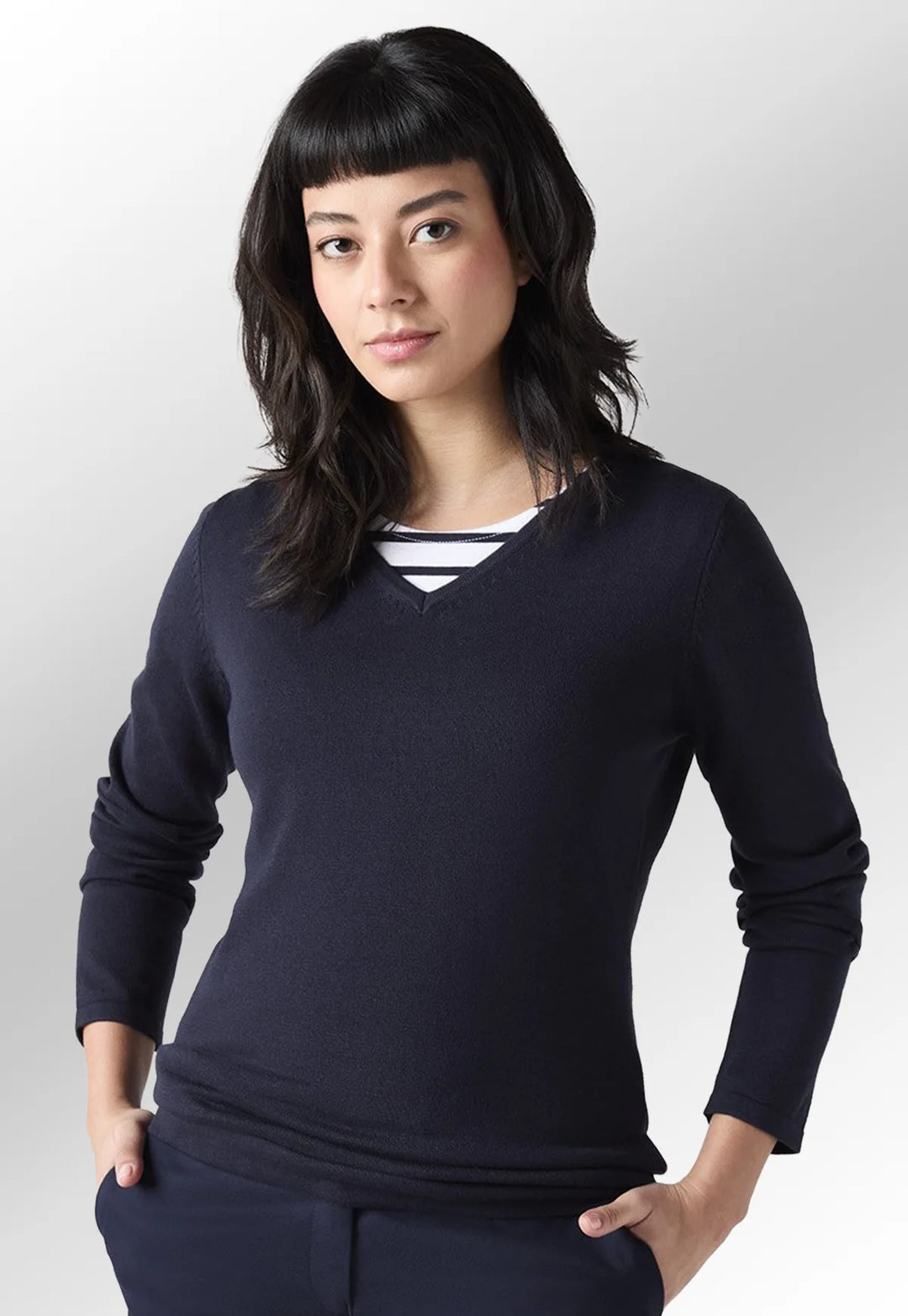 Model wearing the Henbury Women's 12 Gauge V Neck Jumper in Navy.