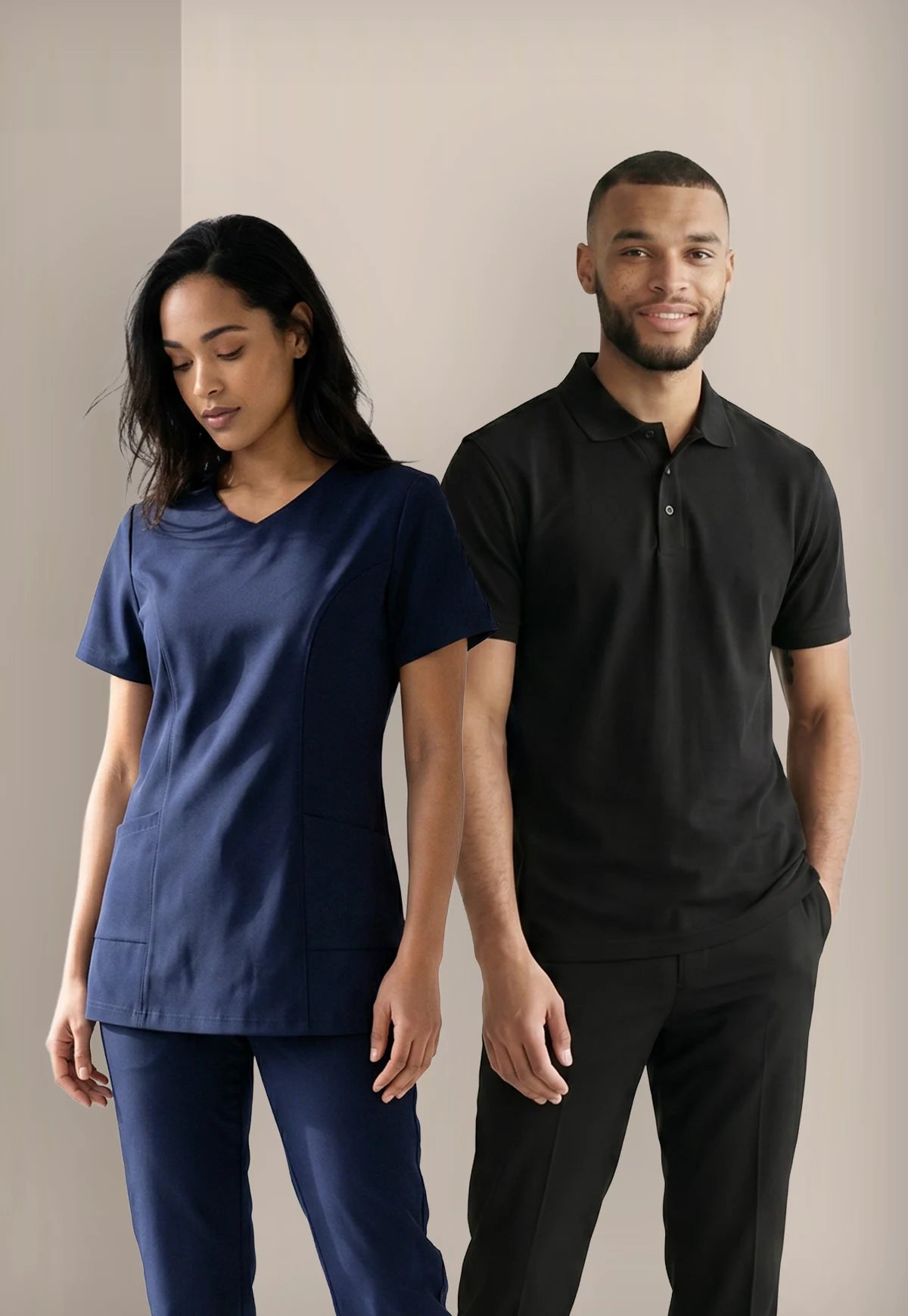 2 models wearing houskeeping uniforms, a navy tunic & black polo shirt