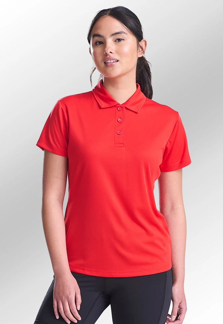 Model wearing the AWDis Ladies Cool Polo JC045 in Fire Red.
