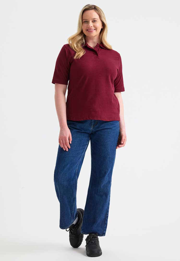 full length model wearing uneek Ladies Classic Polo Shirt in maroon