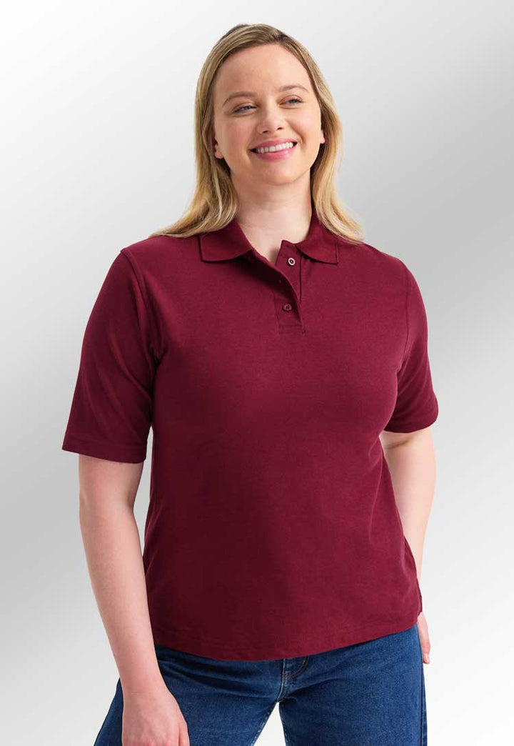 model wearing uneek Ladies Classic Polo Shirt in maroon