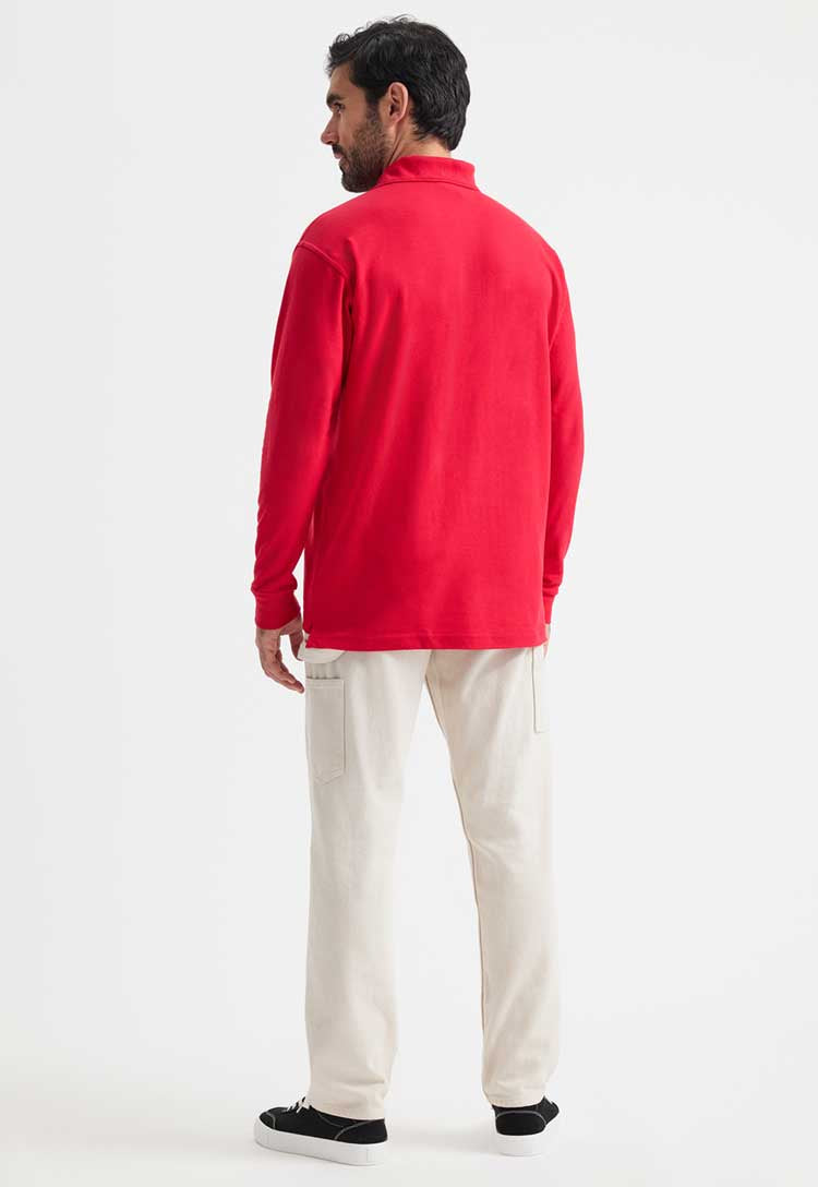 full length back view of model wearing uneek long sleeve polo in red