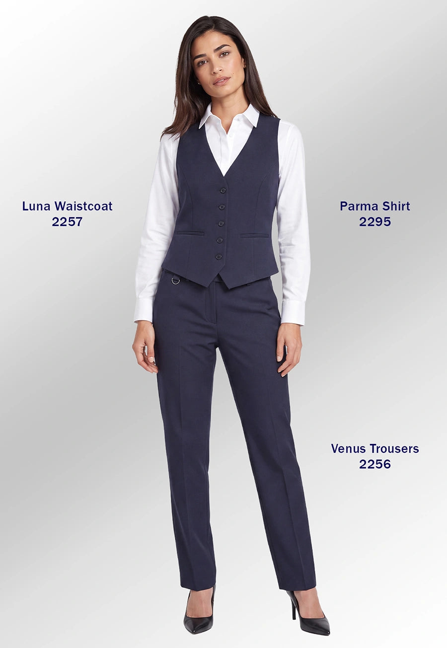 A woman models a navy blue tailored outfit consisting of a vest, white button-up shirt, matching trousers, and black heels against a light gray studio background. Text labels identify the garments as Luna Waistcoat 2257, Parma Shirt 2295, and Venus Trousers 2256.