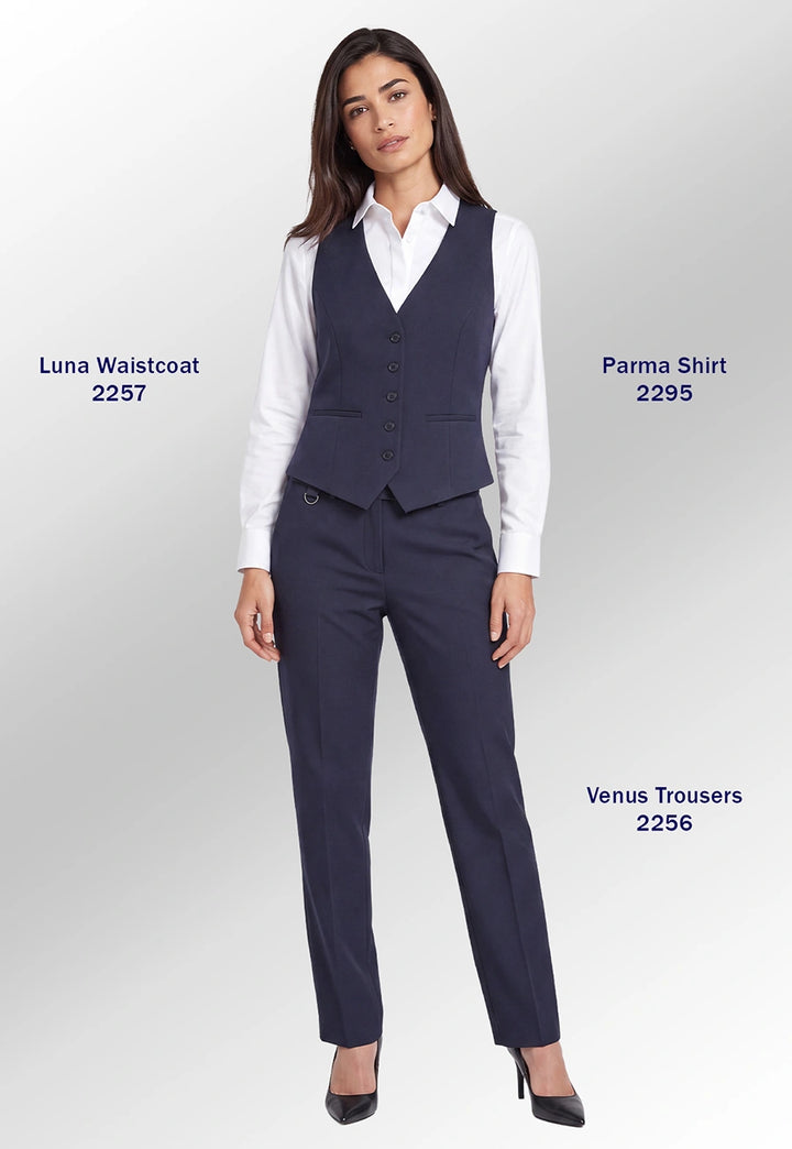 A woman models a navy blue tailored outfit consisting of a vest, white button-up shirt, matching trousers, and black heels against a light gray studio background. Text labels identify the garments as Luna Waistcoat 2257, Parma Shirt 2295, and Venus Trousers 2256.