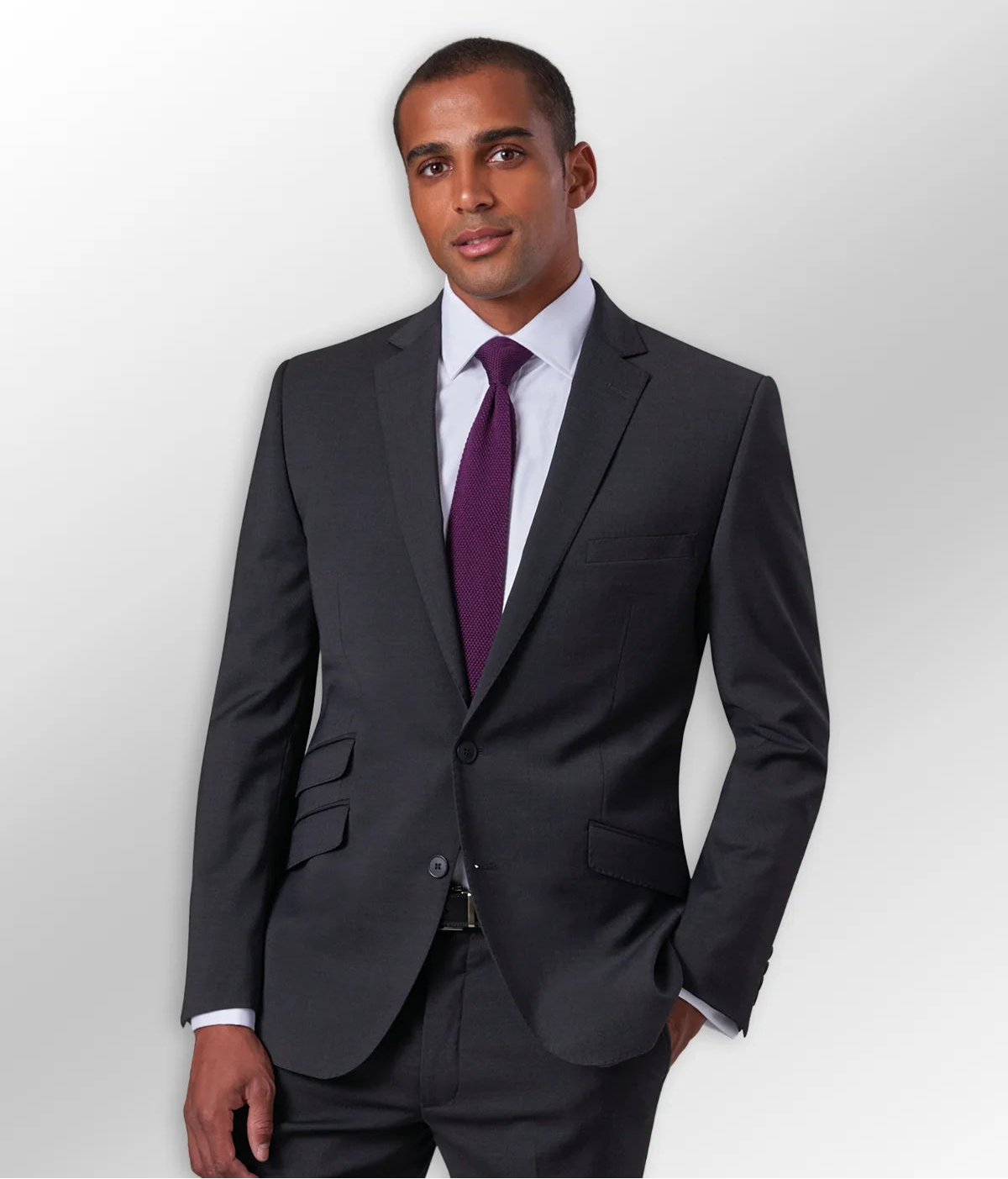 Male model wearing a Black Suit Jacket, Purple Tie, & Black Suit Trousers from the Brook Taverner Men's Work Suits Collection.