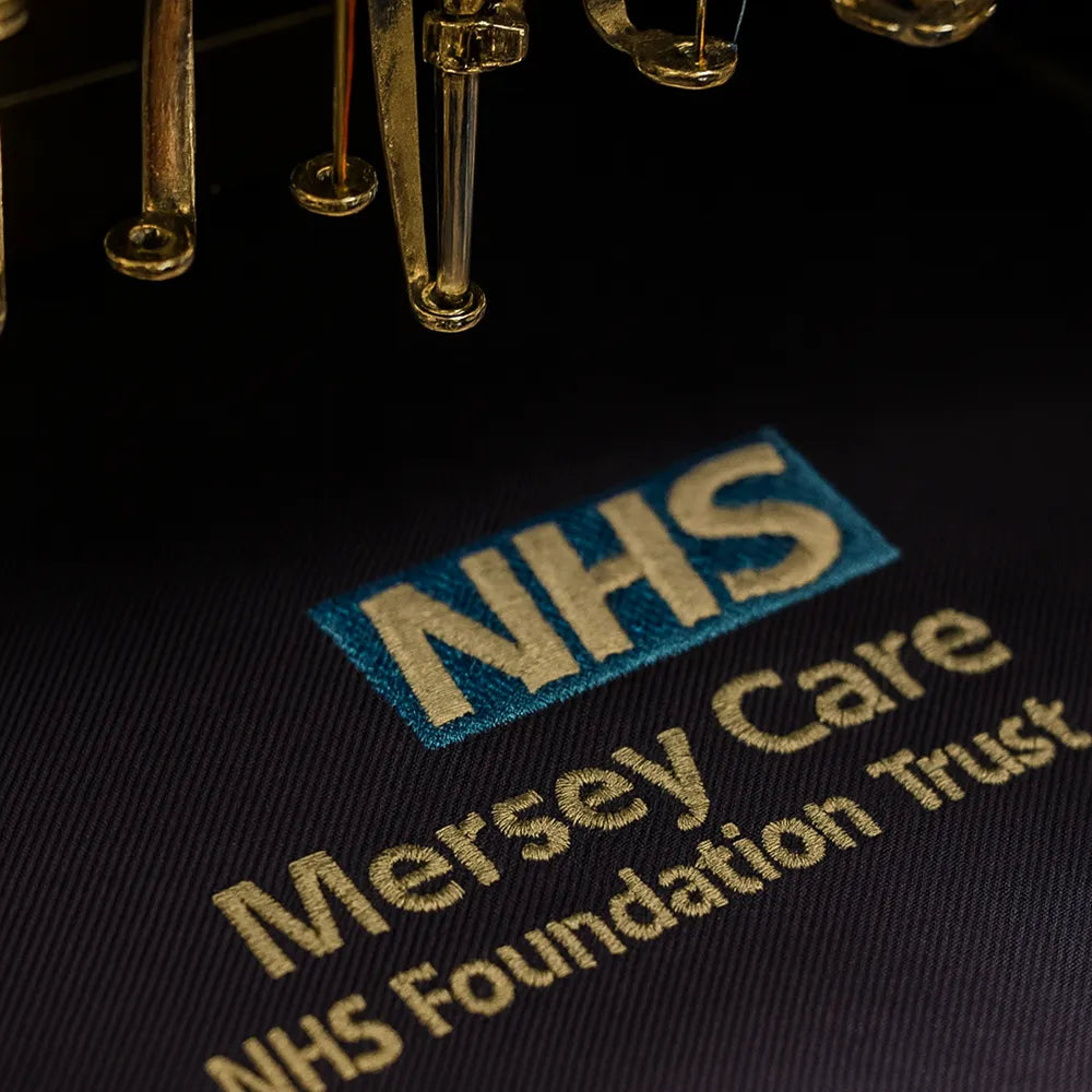 NHS Mersey Care NHS Foundation Trust logo on a dark background