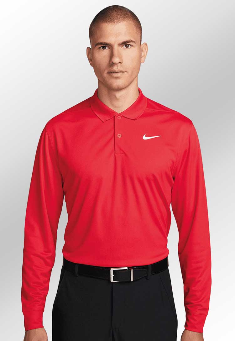 Model wearing Nike Dri-FIT Victory Solid Long Sleeve Polo NK354 in red