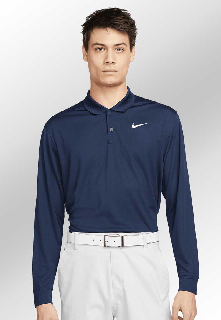 Model wearing Nike Dri-FIT Victory Solid Long Sleeve Polo NK354 in navy