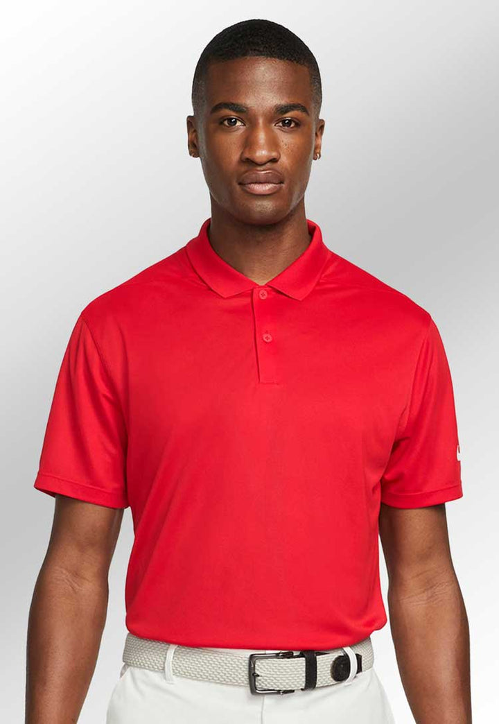 Model wearing Nike Victory Solid Polo NK342 in red 