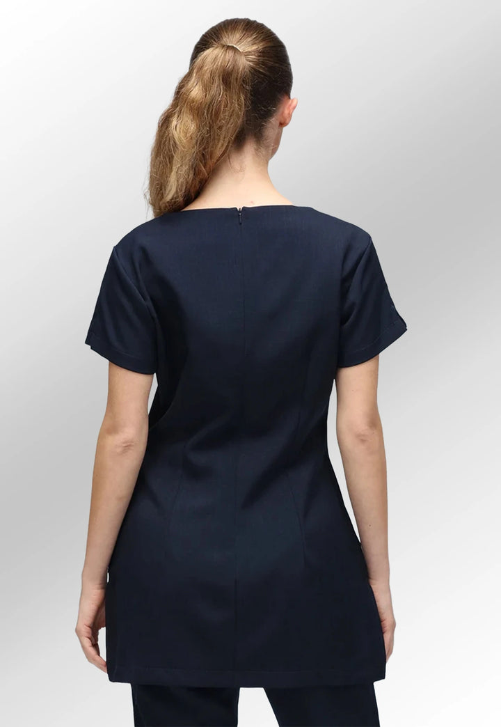 Rear view of model wearing the Navy Nina V Neck Salon Tunic with Pockets.