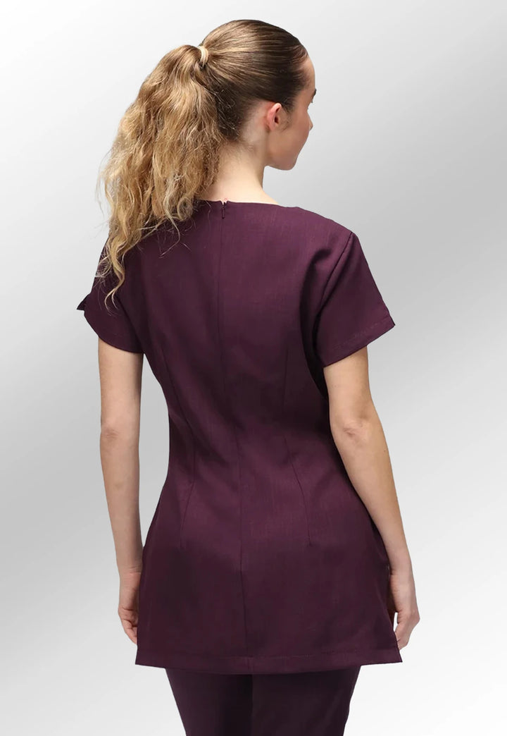 Rear view of model wearing the La Beeby Plum Nina V Neck Salon Tunic with Pockets.