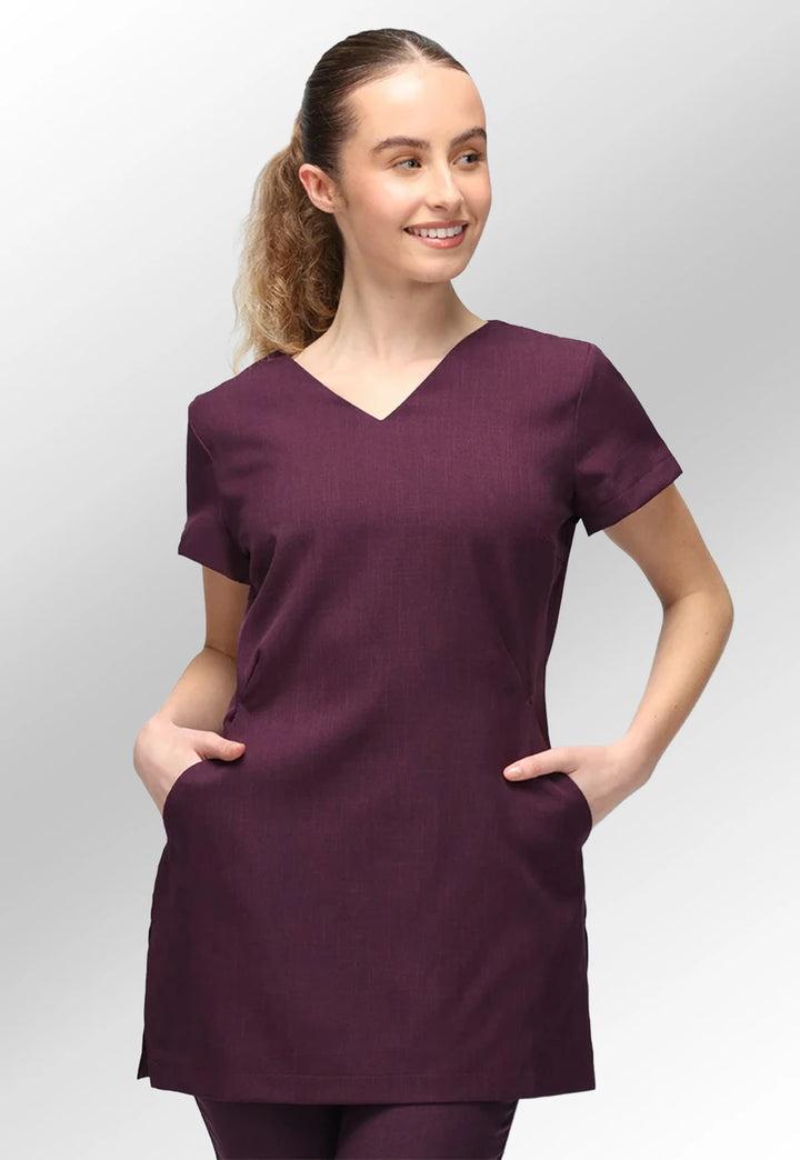 Front view of model wearing the La Beeby Plum Nina V Neck Salon Tunic with Pockets.