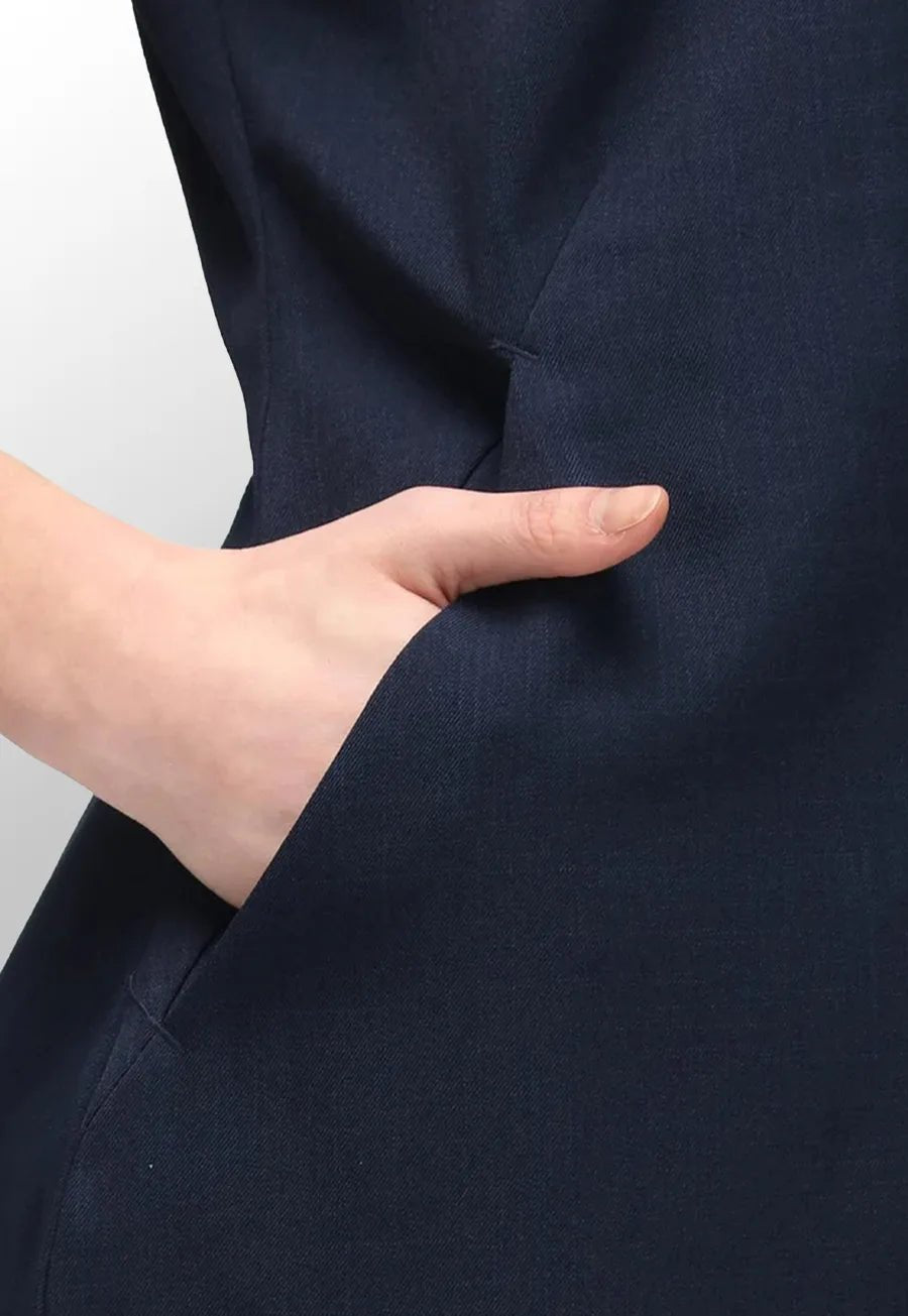 Close-up pocket view of model wearing the La Beeby Navy Nina V Neck Salon Tunic.