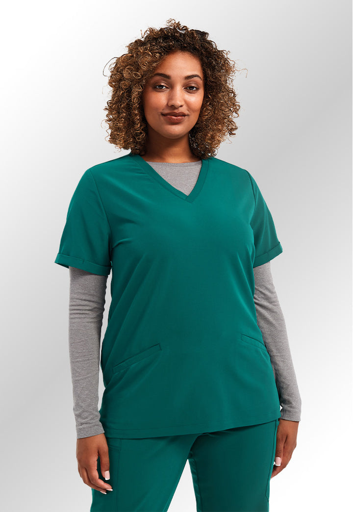 A model wearing an NN310 Women's Invincible Onna-Stretch Tunic in Clean Green