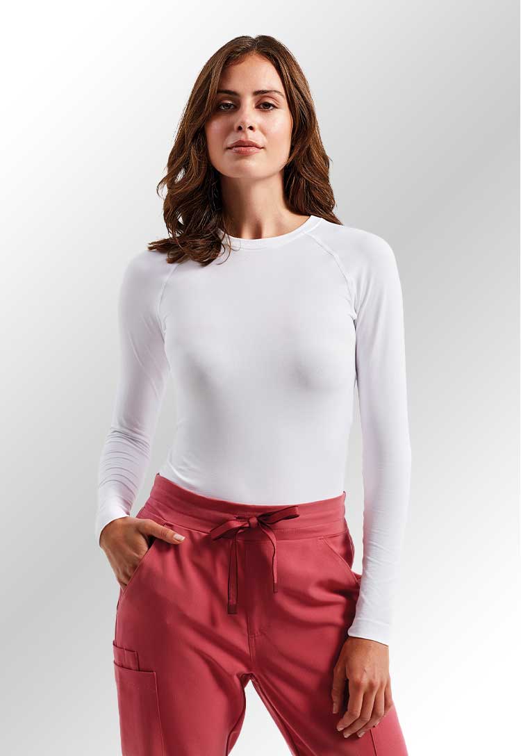 A model wearing an NN370 Women's Unstoppable Fresh Underscrub Baselayer in White