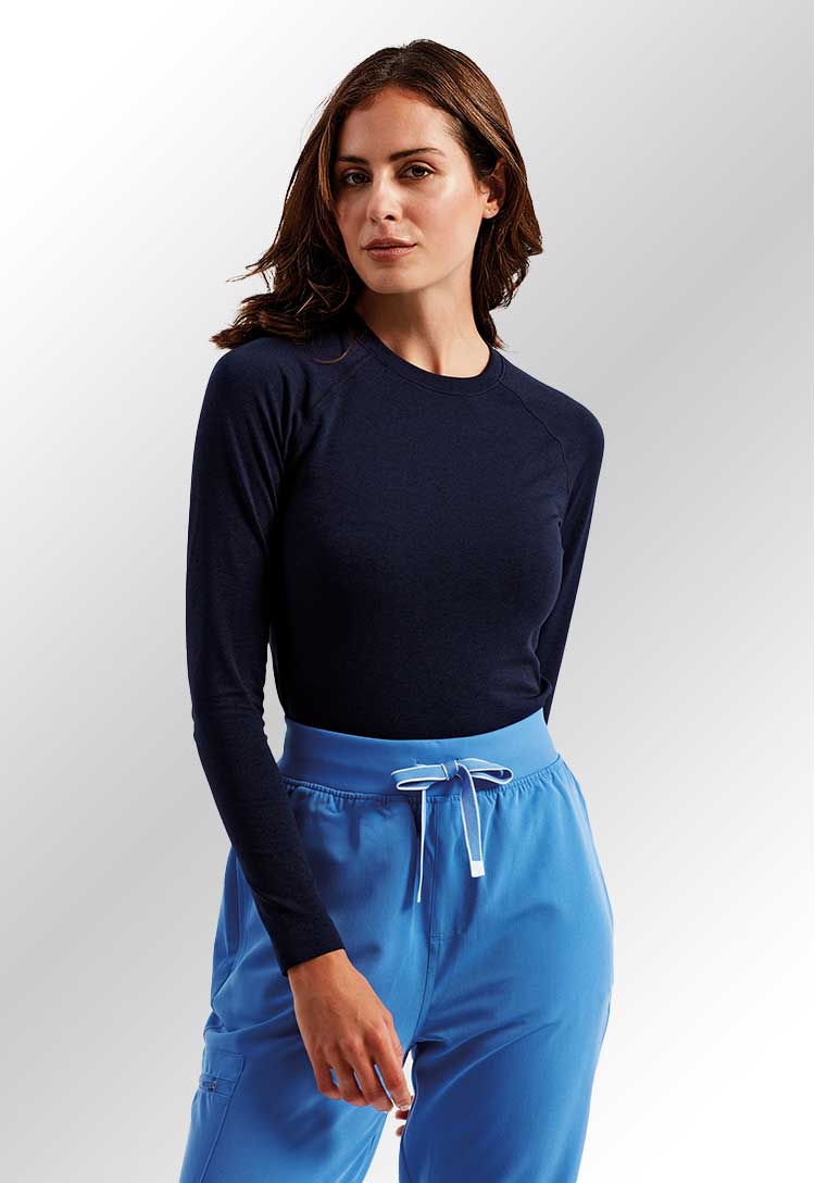 A model wearing an NN370 Women's Unstoppable Fresh Underscrub Baselayer in Navy