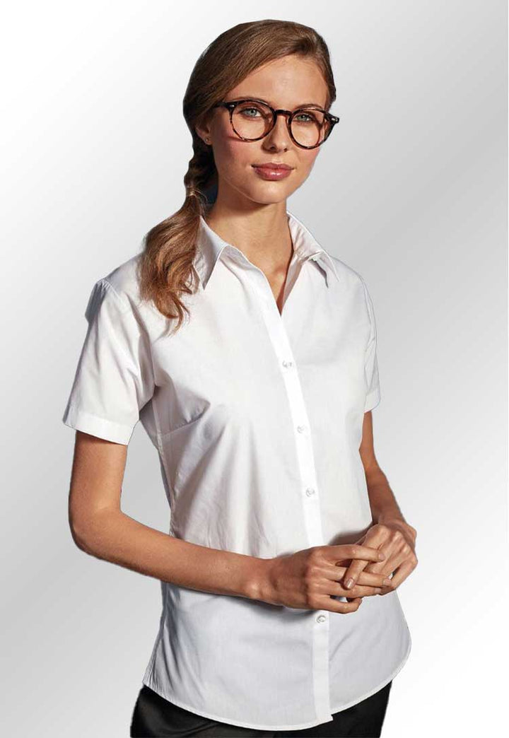 Model wearing a PR309 Women's supreme poplin short sleeve shirt in White