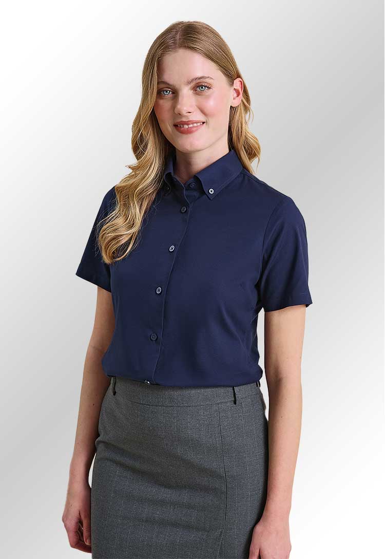 A model wearing a PR386 Womens Supreme Oxford Short Sleeve Shirt in Navy