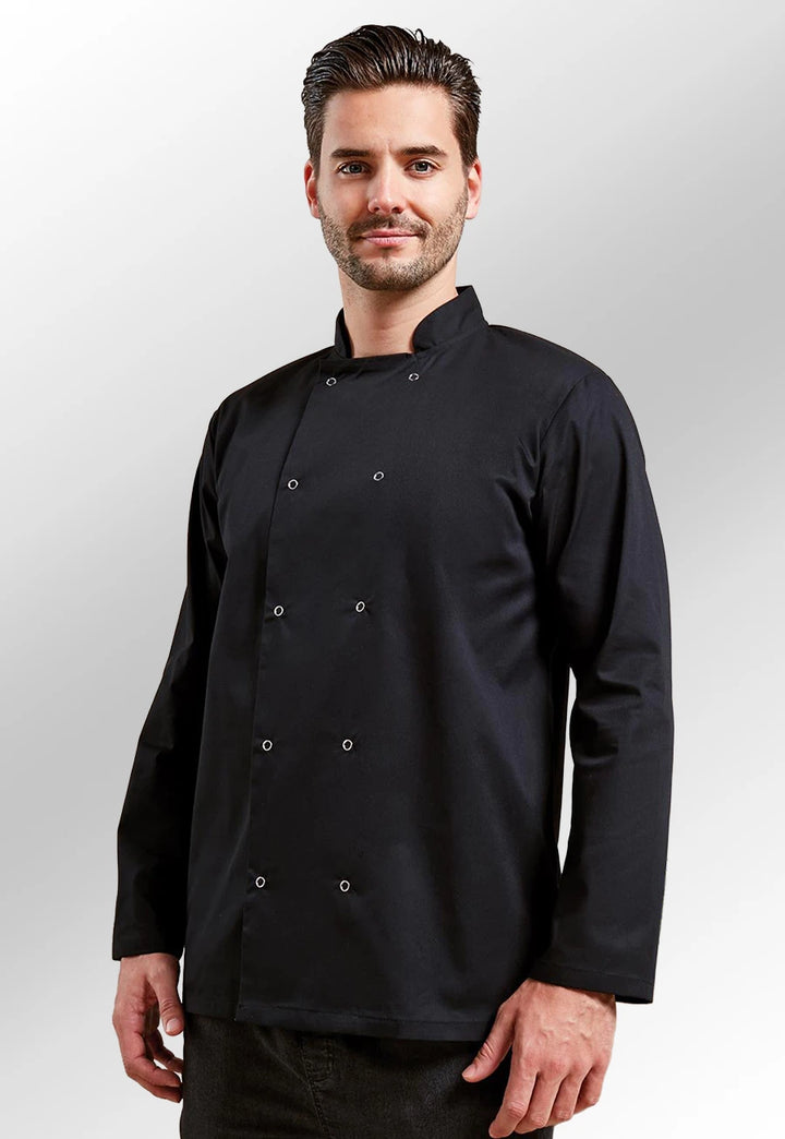 Model wearing the Studded Front Long Sleeve Chef's Jacket PR665 in Black.