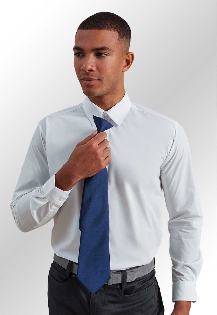 Model in white shirt holding a PR785 'Colours Originals' fashion clip tie in Royal