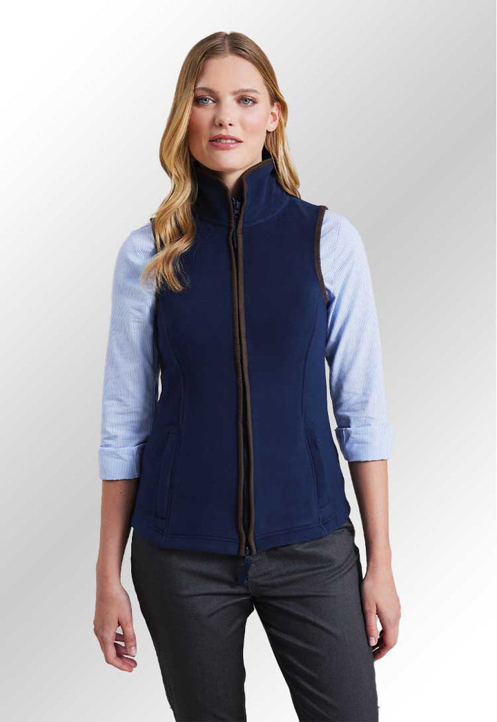 Model wearing a PR804 Women’s artisan fleece gilet in Navy/Brown