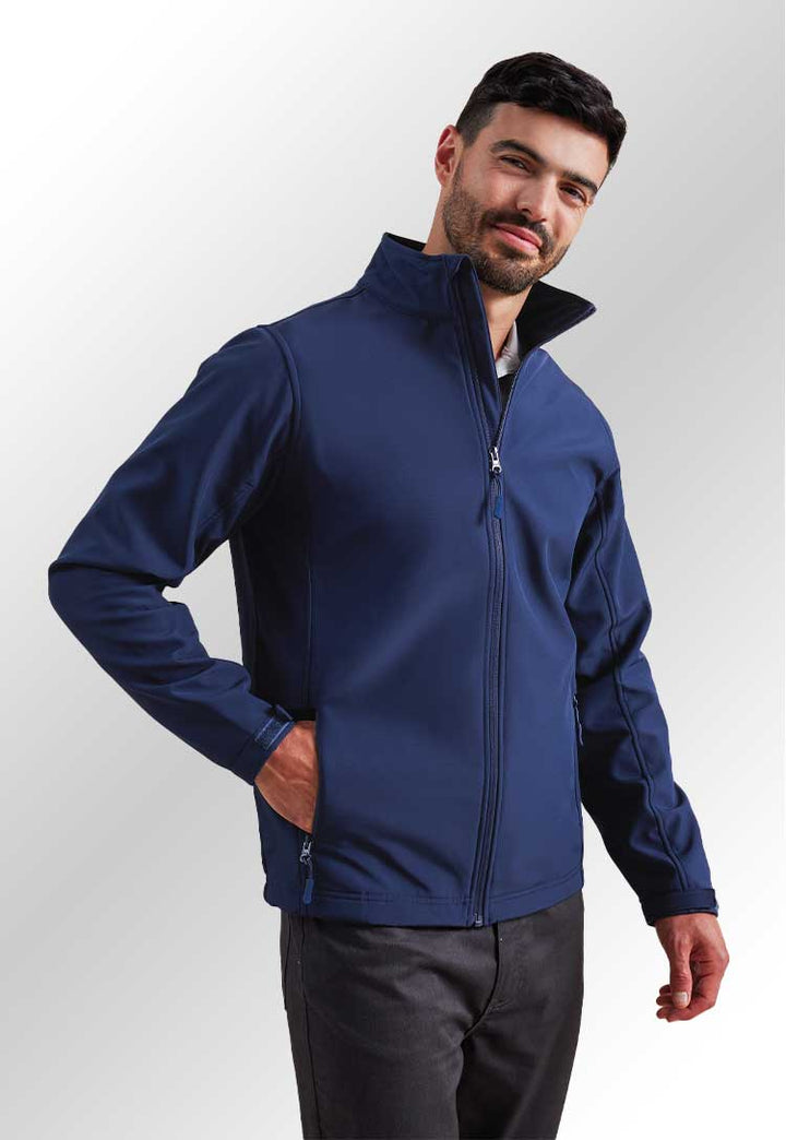 Model wearing PR810 Windchecker® printable and recycled softshell jacket in Navy