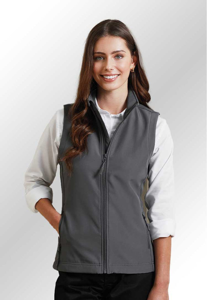 Model wearing a PR816 Women’s Windchecker printable and recycled gilet in Charcoal