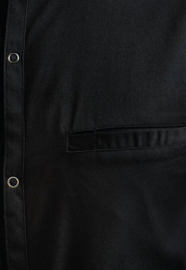 Close-up of the Premier Workwear Chef's 'Recyclight' Short Sleeve Shirt PR904 in Black.