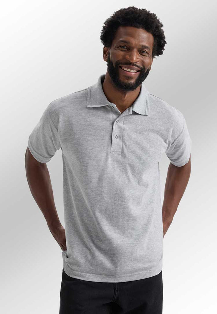 model wearing premium polo from uneek in heather grey