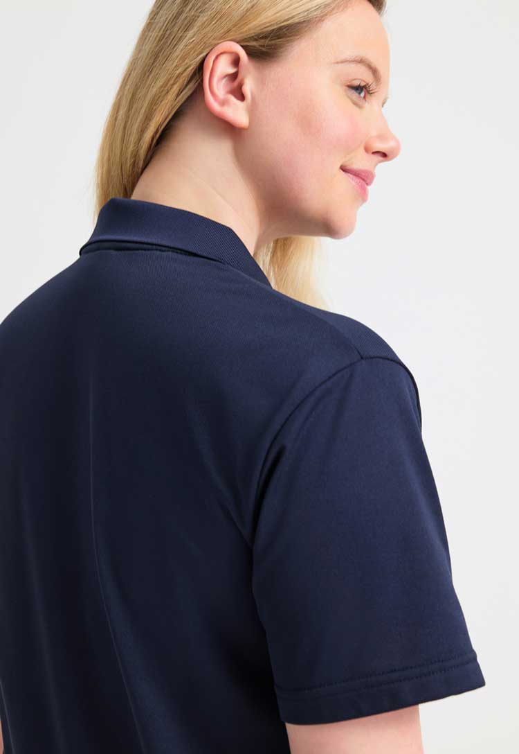 close uo back view of model wearing uneek Processable Polo Shirt  in navy