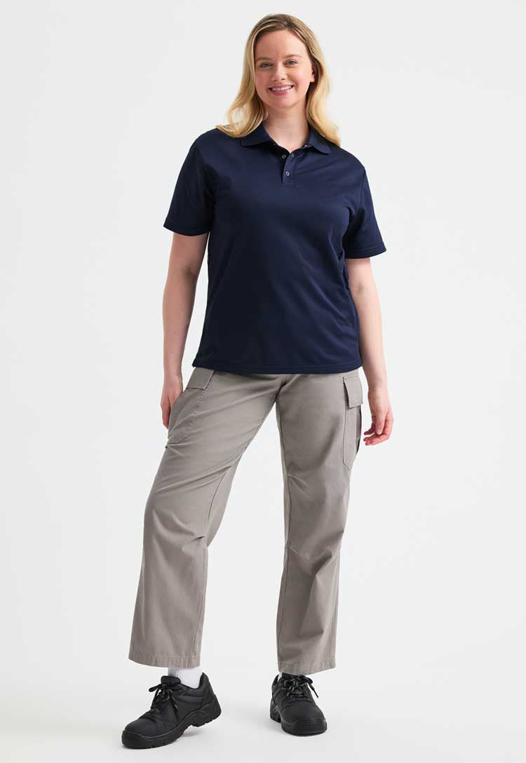 full length model wearing uneek Processable Polo Shirt  in navy