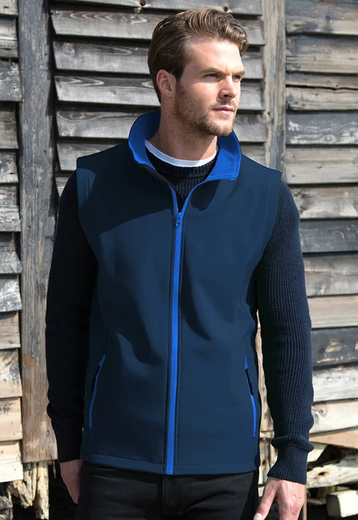 Model wearing the Men's Printable Softshell Bodywarmer R232M in Navy/Royal.