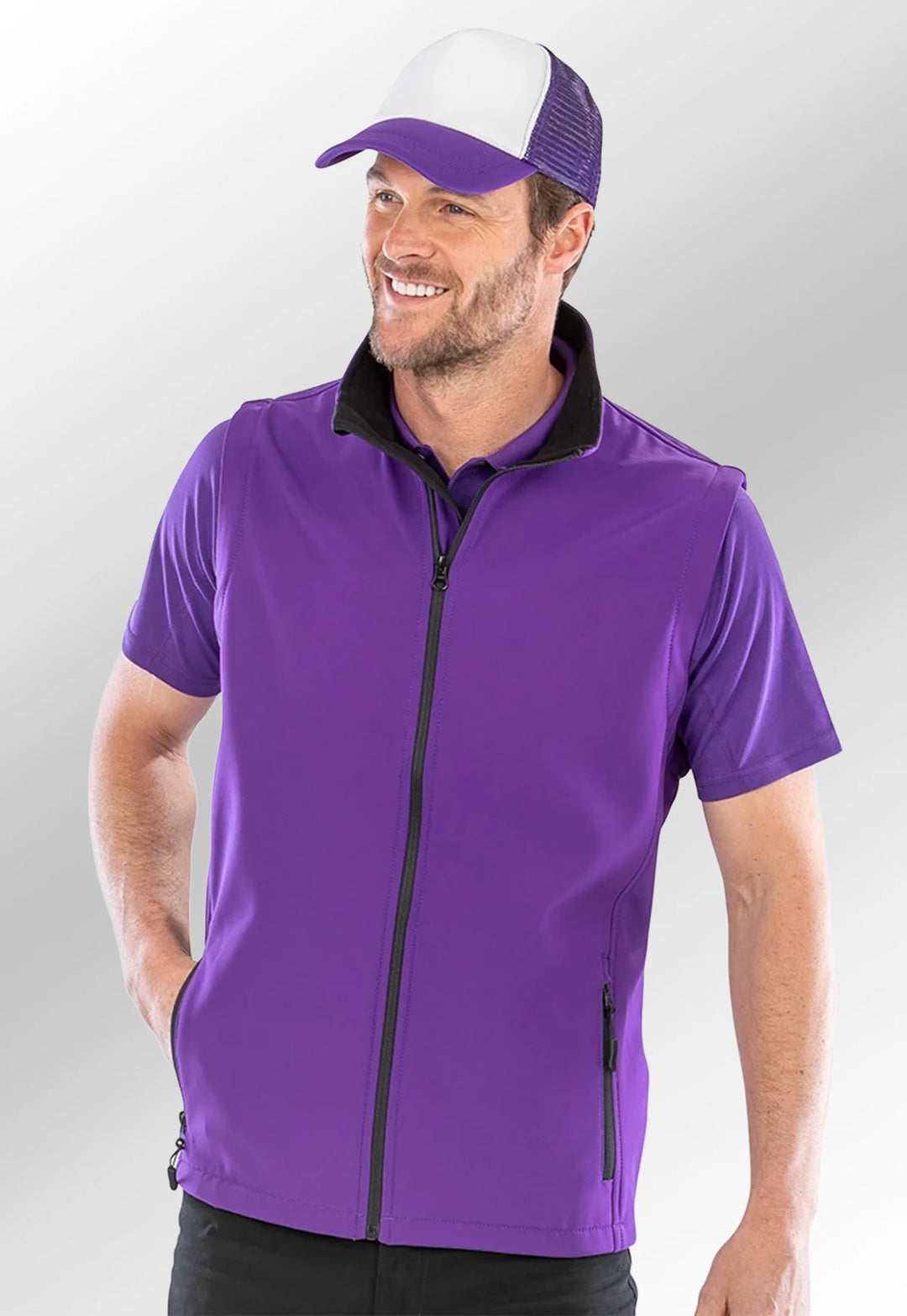 Model wearing the Men's Printable Softshell Bodywarmer R232M in Purple/Black.