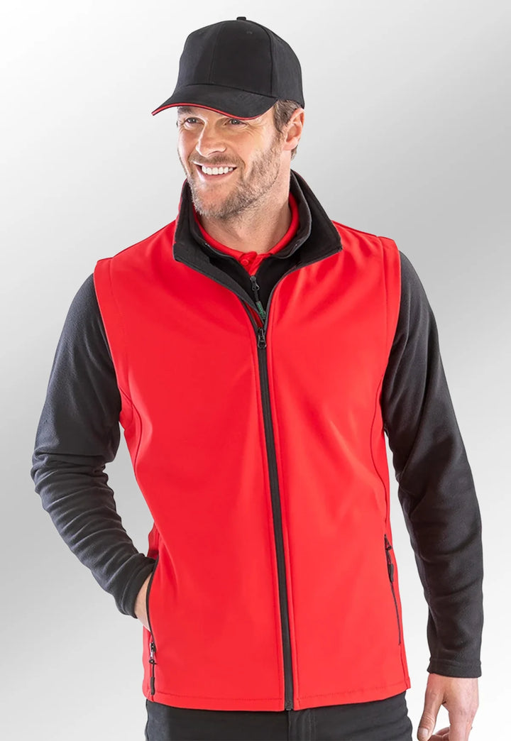 Model wearing the Men's Printable Softshell Bodywarmer R232M in Red/Black.