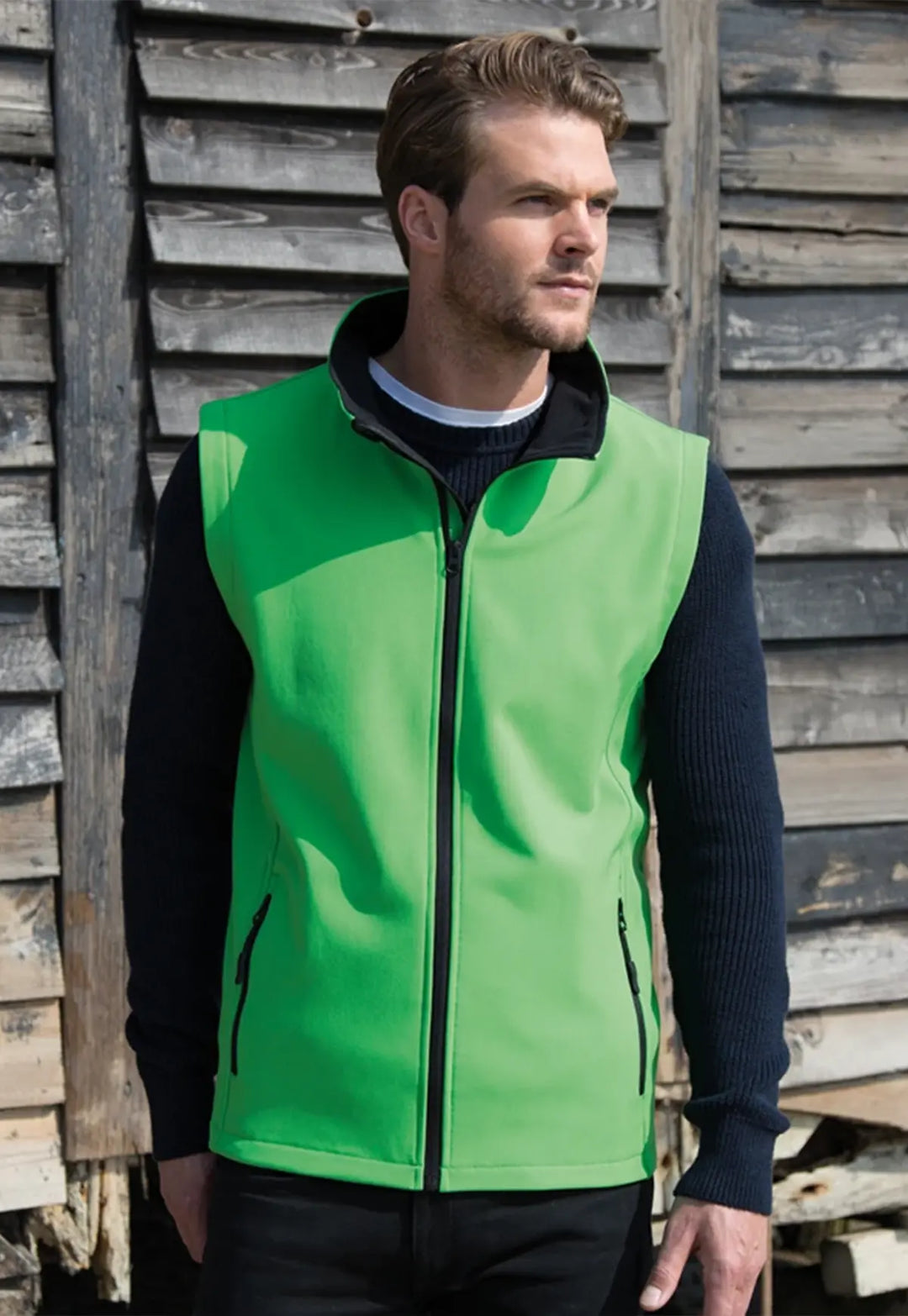 Model wearing the Men's Printable Softshell Bodywarmer R232M in Vivd Green/Black.